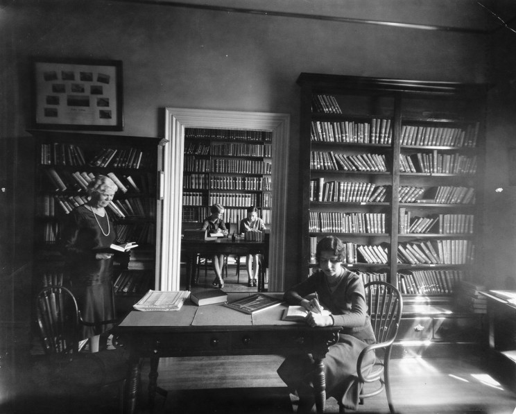 Historic image of female ֱ students studying in library